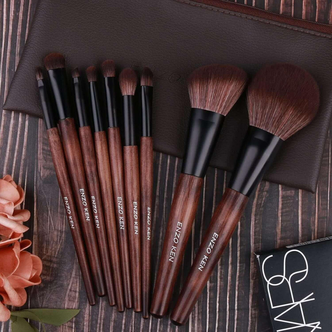 Set of Enzo Ken makeup brushes with wooden handles and soft bristles on wooden background