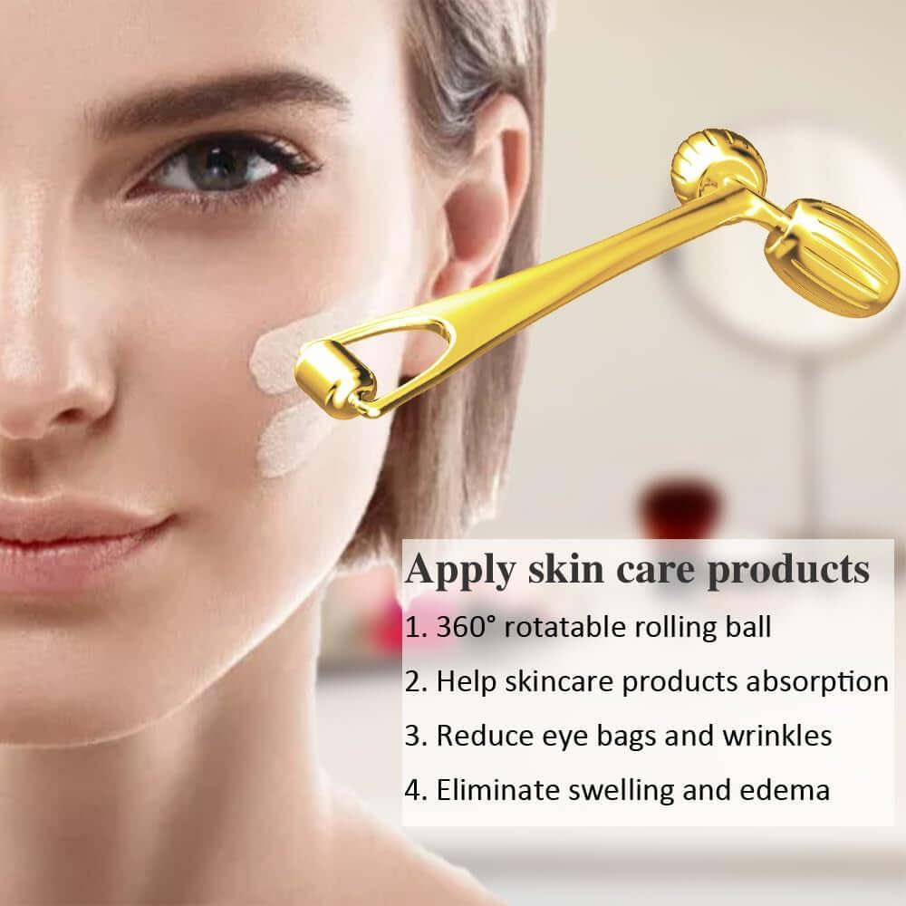 Woman applying cream with gold 360° rotatable rolling ball facial skincare massager