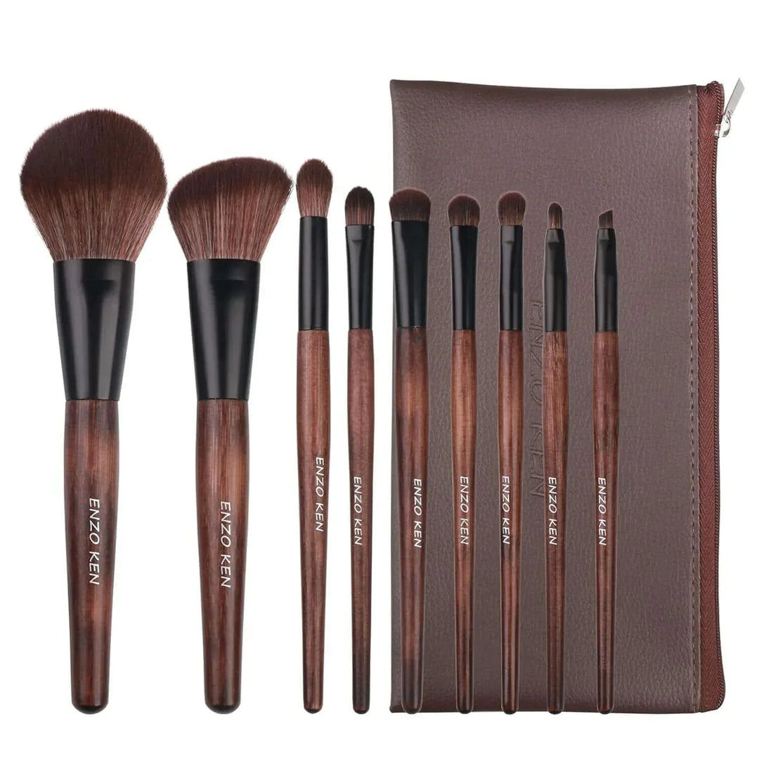 Set of nine Enzo Ken makeup brushes with wooden handles and a brown zippered pouch