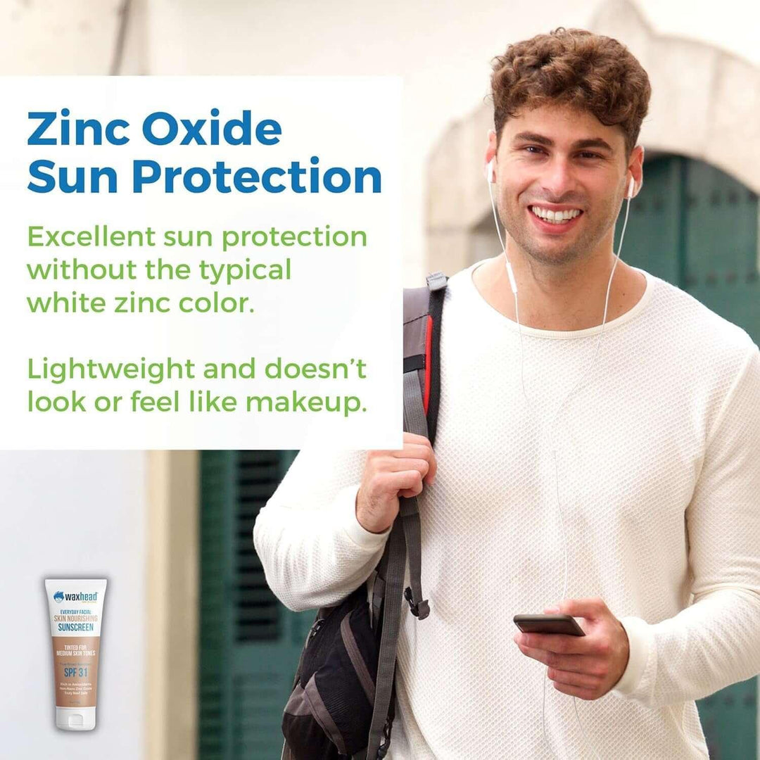 Young man smiling outdoors wearing white shirt with earbuds and backpack promoting zinc oxide sun protection sunscreen