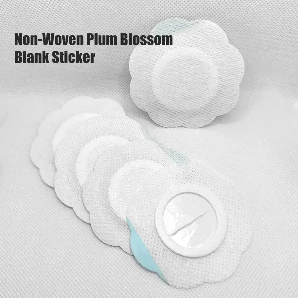 Non-woven plum blossom shaped blank stickers arranged on textured white fabric