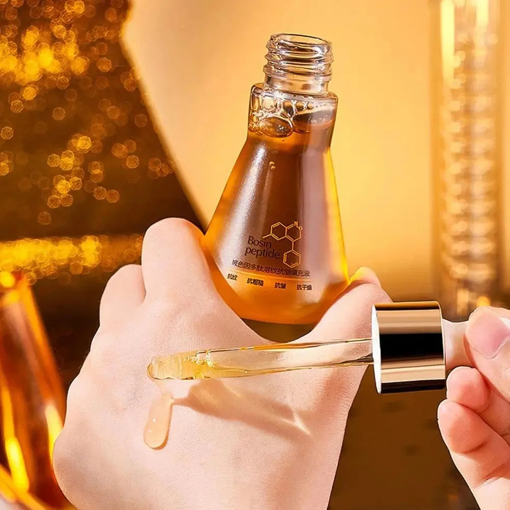 Person applying Bosin peptide serum with dropper onto hand in golden skincare product setting