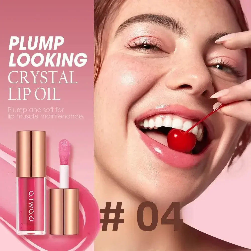 Smiling woman with glossy pink lips holding a cherry, promoting plump looking crystal lip oil #04