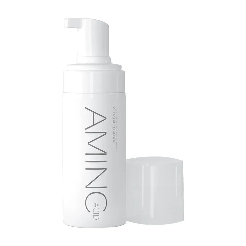 White bottle of aminic acid facial cleanser foam with pump and cap on white background