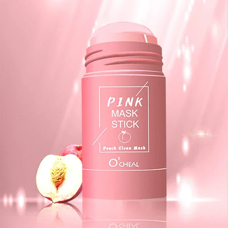 Pink mask stick cosmetic product with peach clean mask label next to half a peach on a pink background
