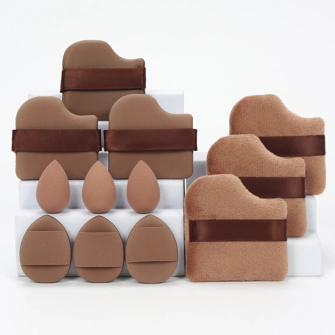 Brown and beige makeup sponges and applicator pads with satin straps displayed on white steps
