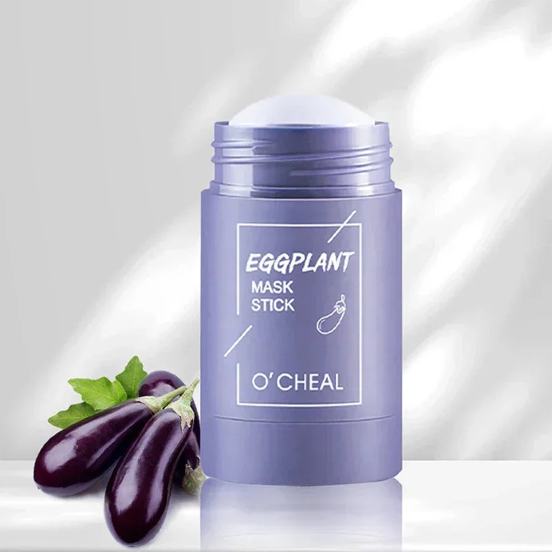 O'CHEAL Eggplant Mask Stick purple skincare product with fresh eggplants on reflective surface