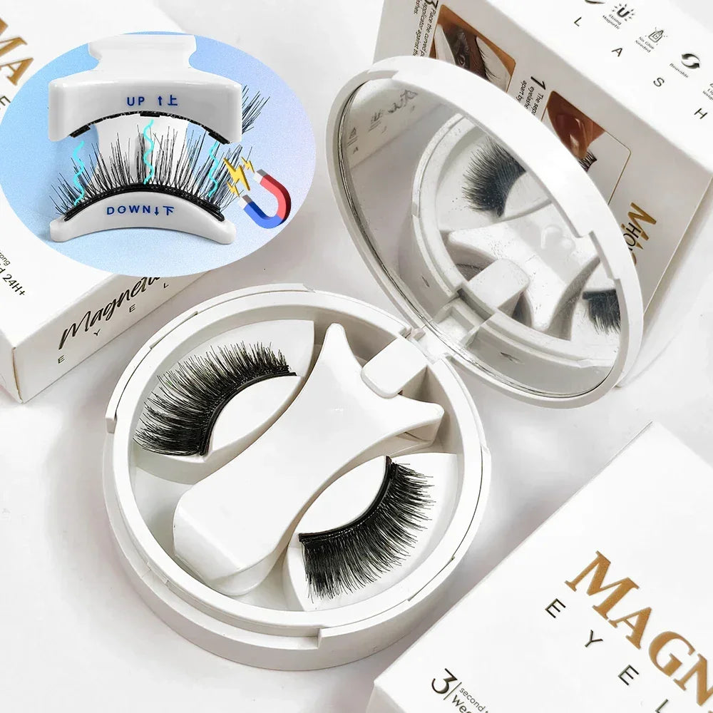Magnetic eyelash set with black lashes, white applicator, and compact mirror on a white surface