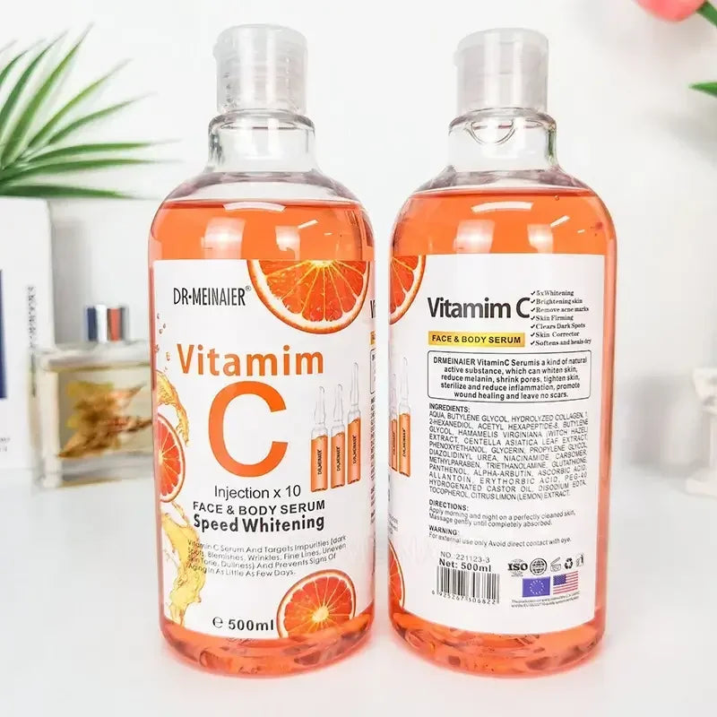 Two 500ml bottles of DR MEINAIER Vitamin C face and body serum with orange slices, speed whitening