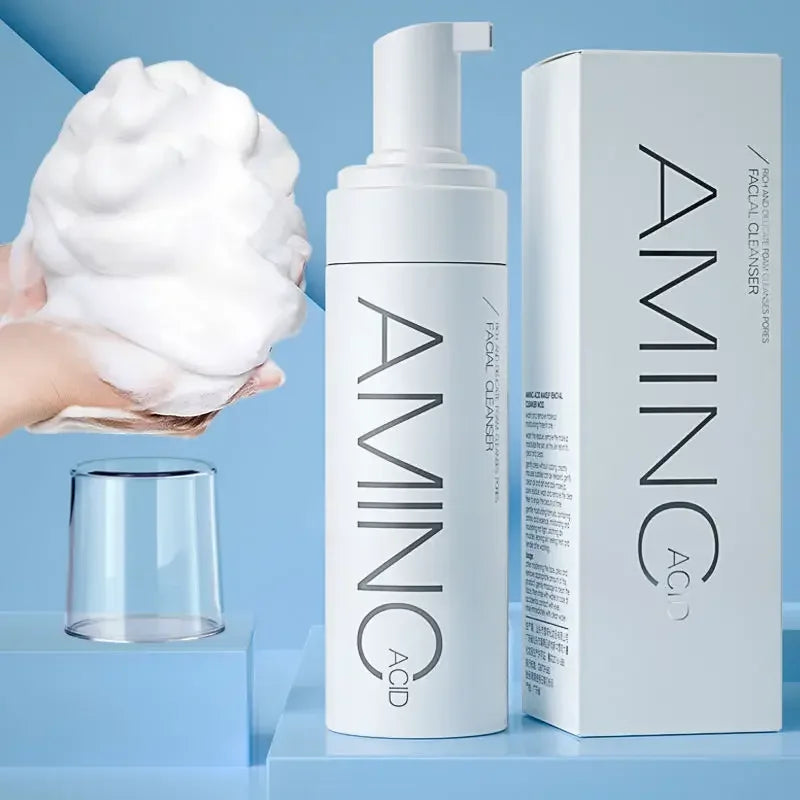 Amino Acid facial cleanser bottle and box on blue surface with foam in hand for skincare