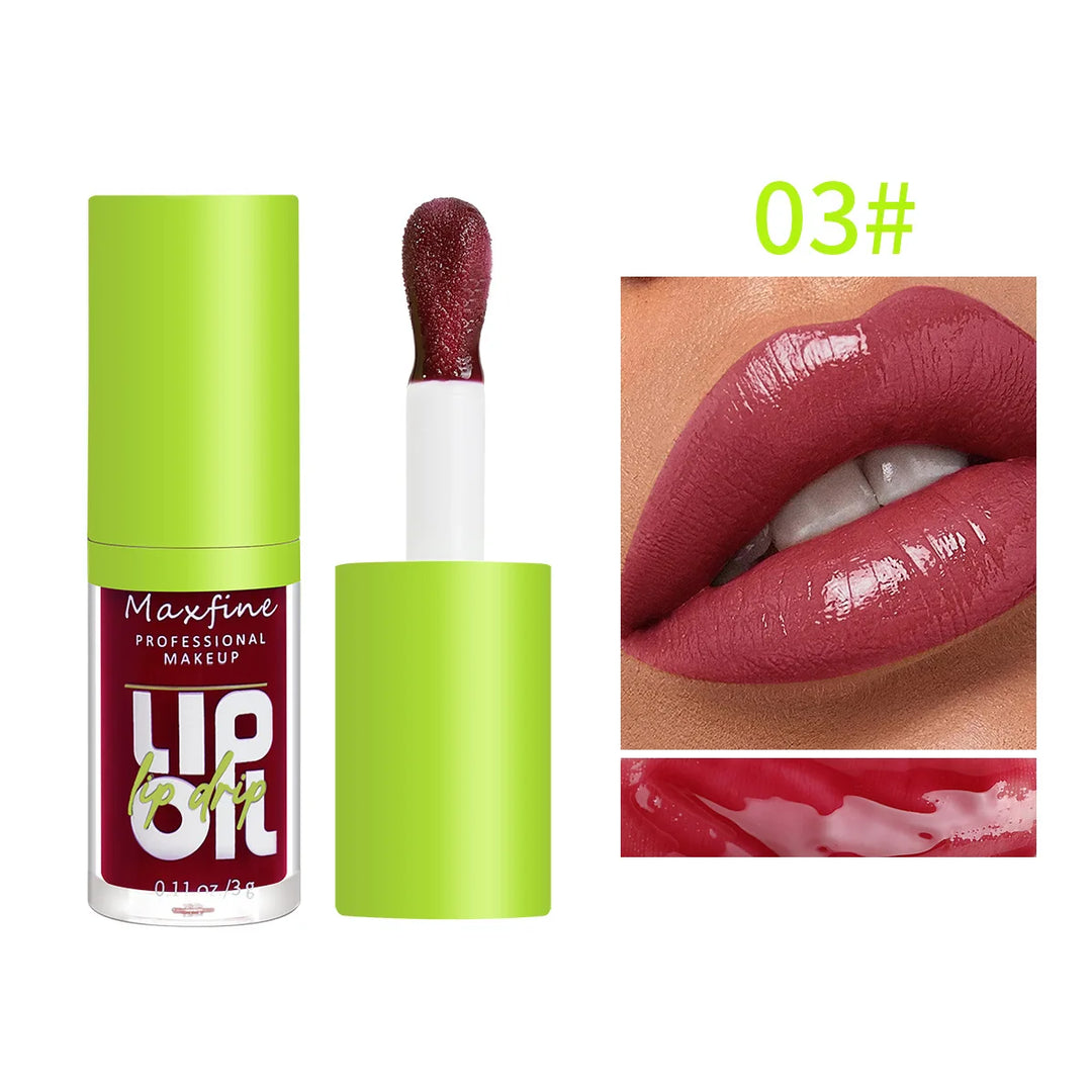 Maxfine professional makeup lip oil in green cap with applicator, deep red lip color shade 03 applied on lips