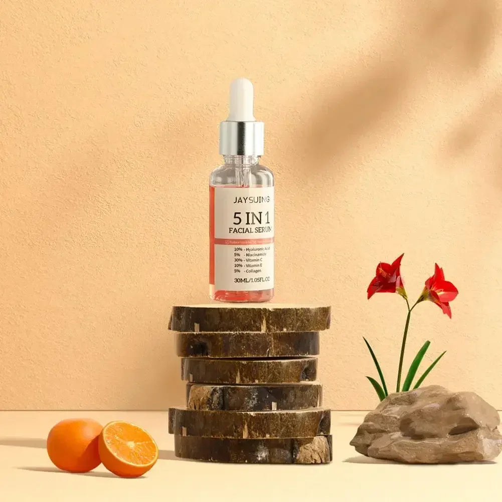 5 in 1 facial serum bottle on stacked wood slices with orange halves and red flowers