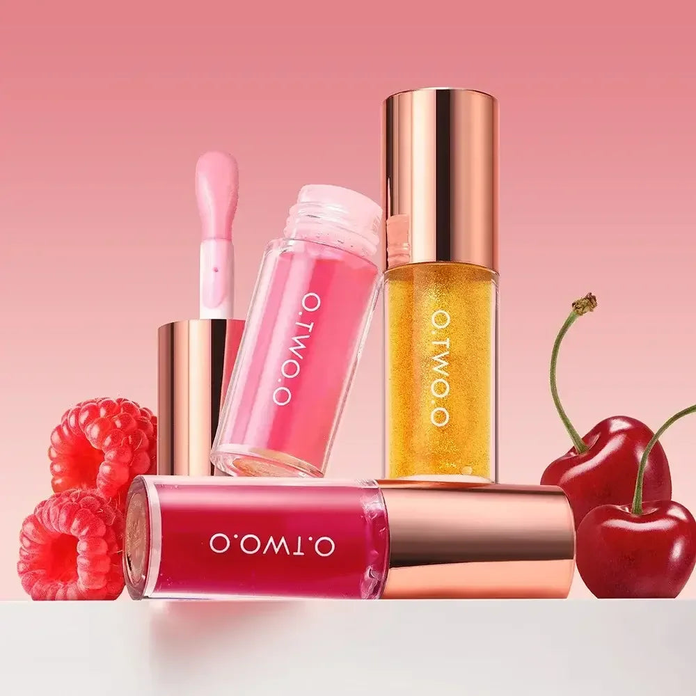 O.TWO.O lip gloss collection with raspberry and cherry fruit on pink gradient background