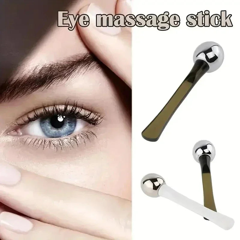 Close-up of blue eye with fingers around it and two metal eye massage sticks for relaxation and skincare