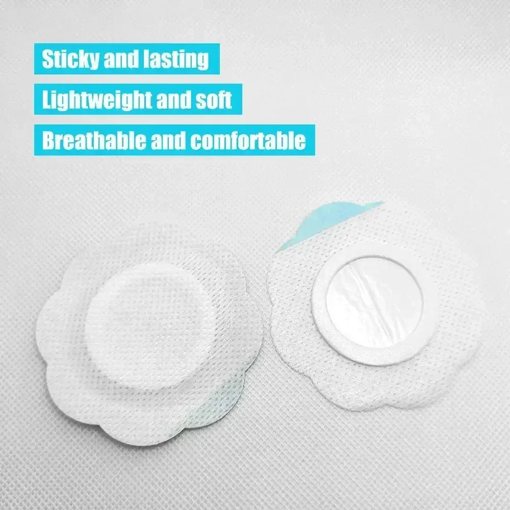 Two white flower-shaped breathable medical adhesive patches on textured fabric background