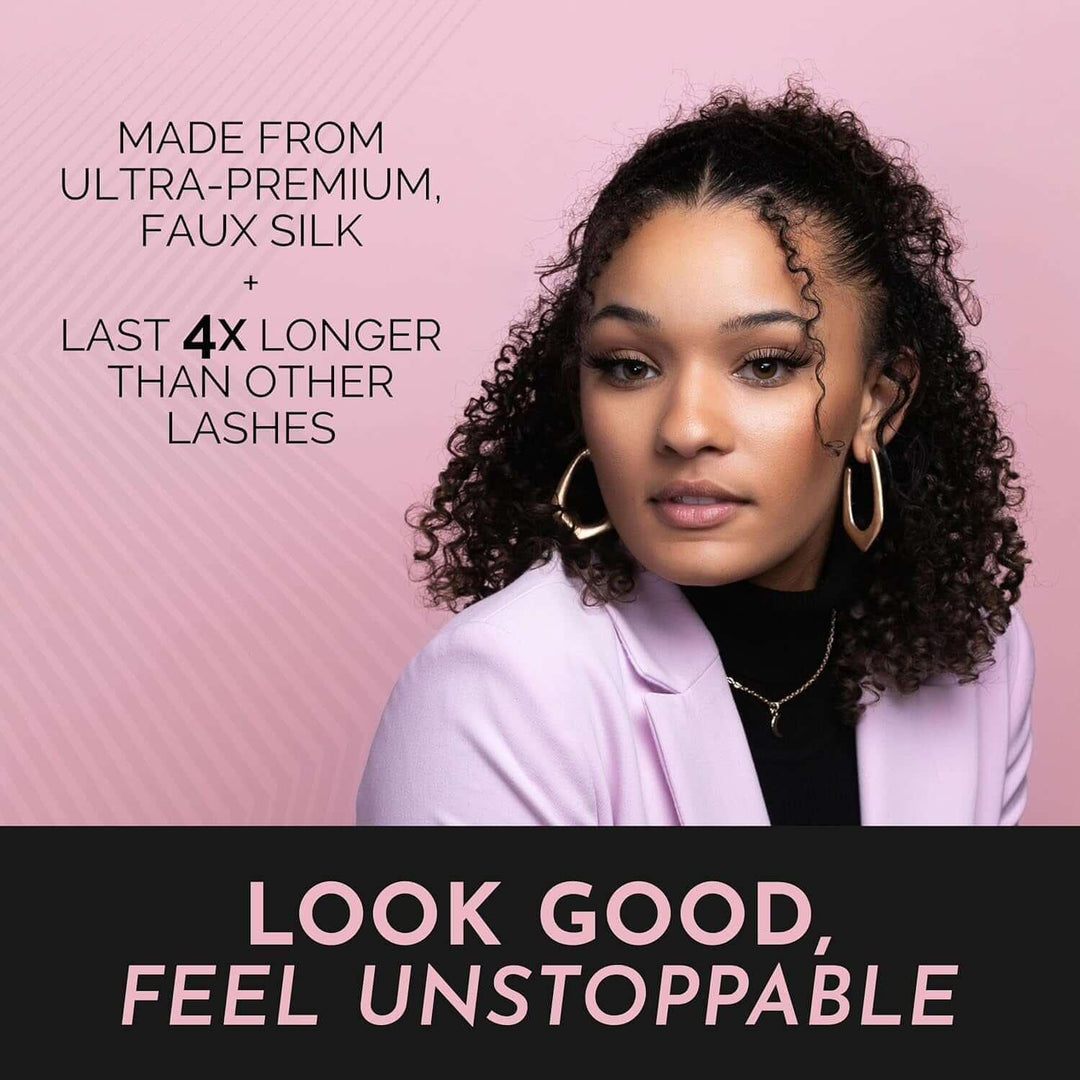 Confident woman with curly hair wearing natural false lashes, gold earrings, and lavender blazer on pink background